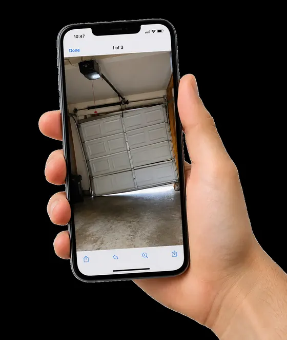 A phone showing a photo of a garage door sent in by a customer